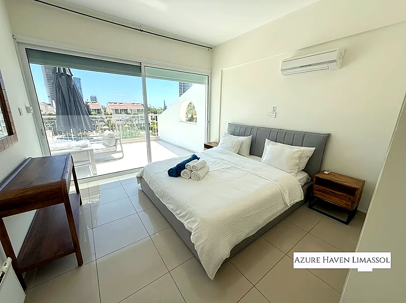 Main bedroom with king-size bed and balcony doors