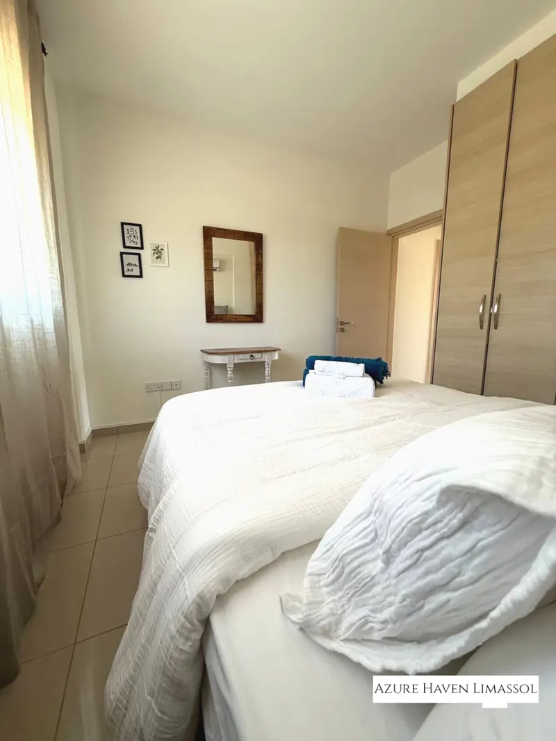 Second bedroom with queen-size bed and wardrobe